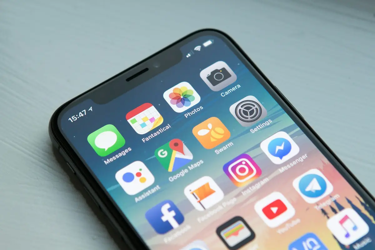 Person holding a smartphone showing a mobile application interface